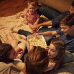 Overhead View Of Family Enjoying Movie Night At Home Together